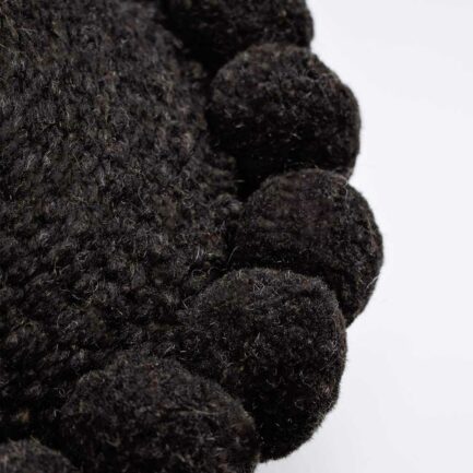 Mini coussin rond à pompons noir
